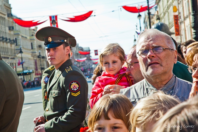 Little girl with her father, waiting for the Victory Day Parade to begin in Saint Petersburg, Russia.