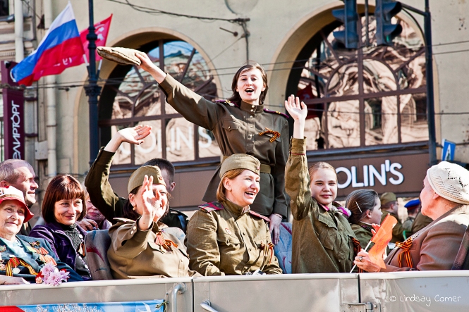 Юююююррррррааааа! Young woman waving to the crowd in the Victory Day Parade; Saint Petersburg, Russia.
