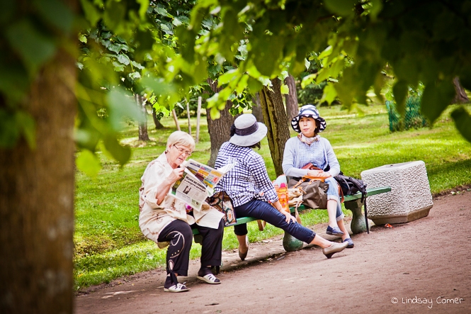 Women sitting on a bench in the park at Peterhof, Saint Petersburg, Russia.