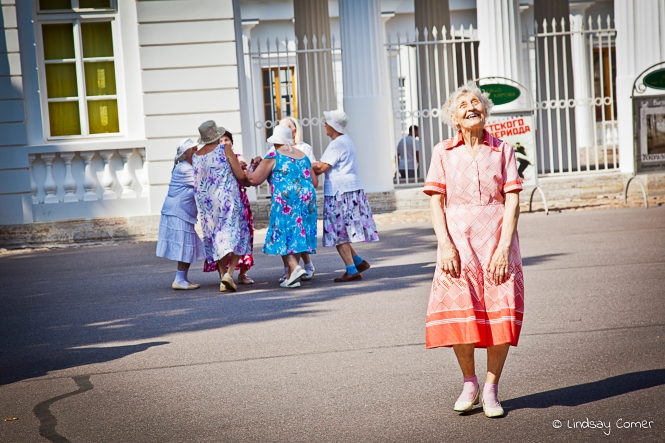 The dancing babushka joyfully laughing after she finishes her dance; Yelagin Ostrov, Saint Petersburg, Russia. 